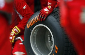 Ferrari technicians handle a Pirelli wet